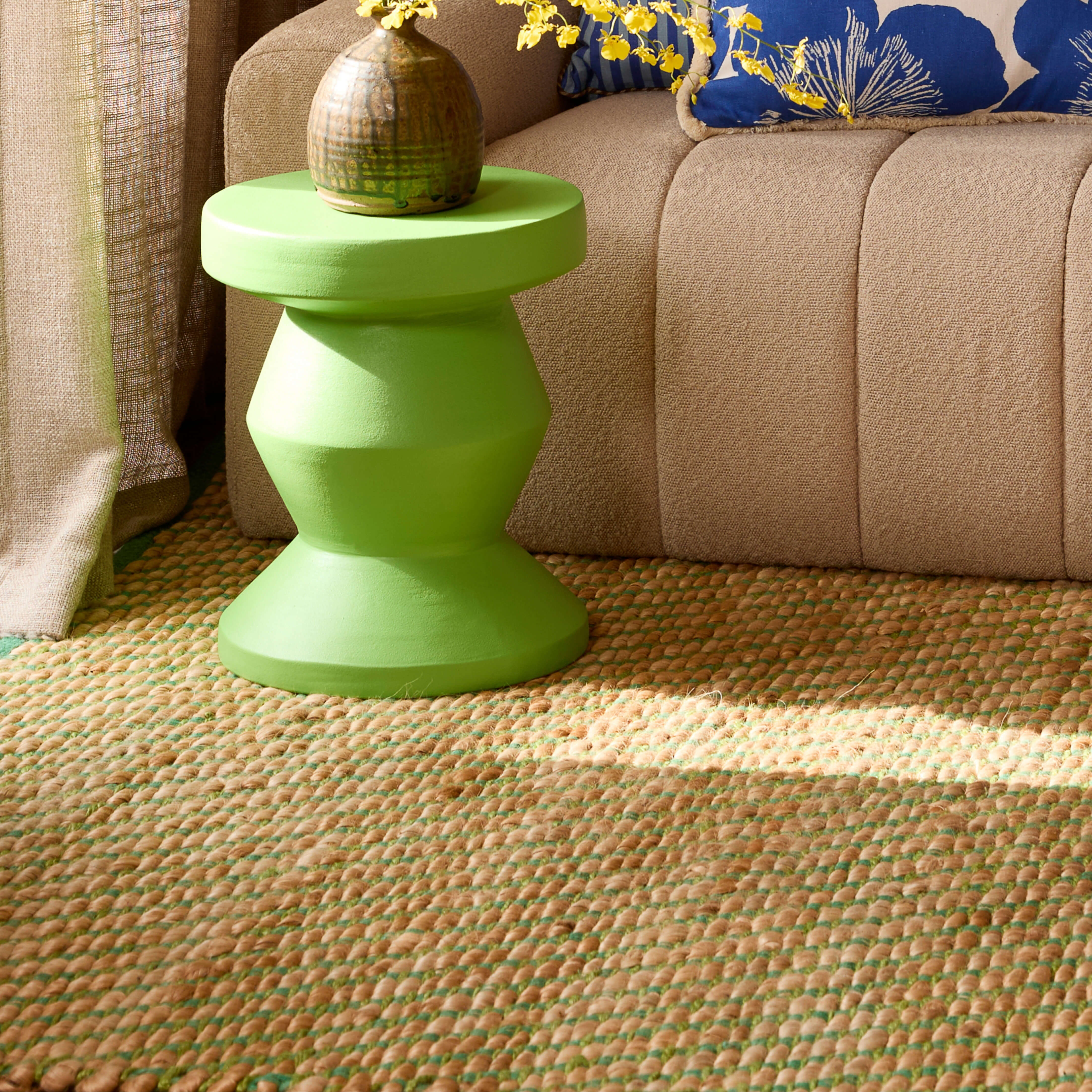 Cushions on a couch with a jute rug on the floor