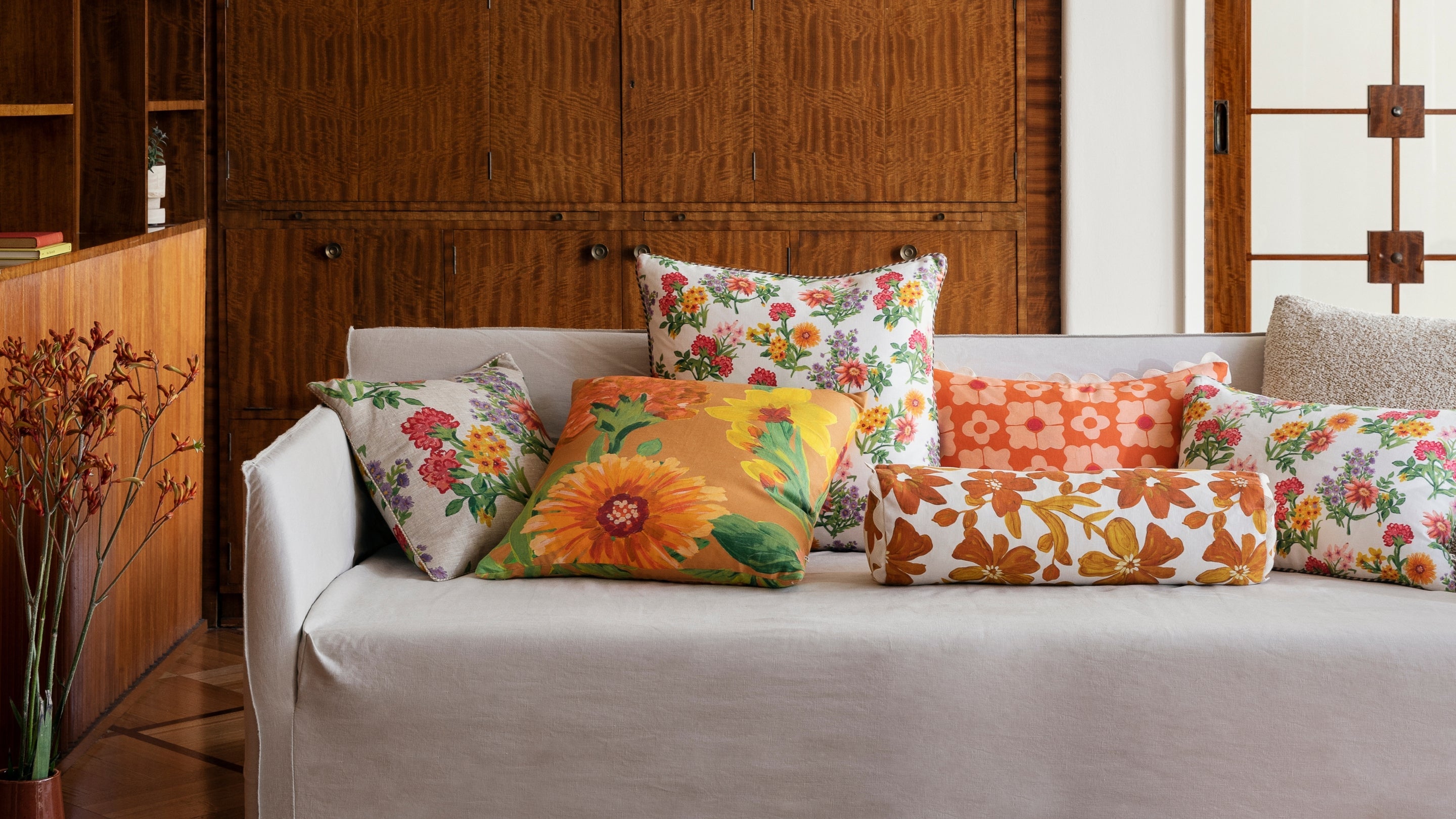 Floral Cushions In Warm Tones On Cream Sofa