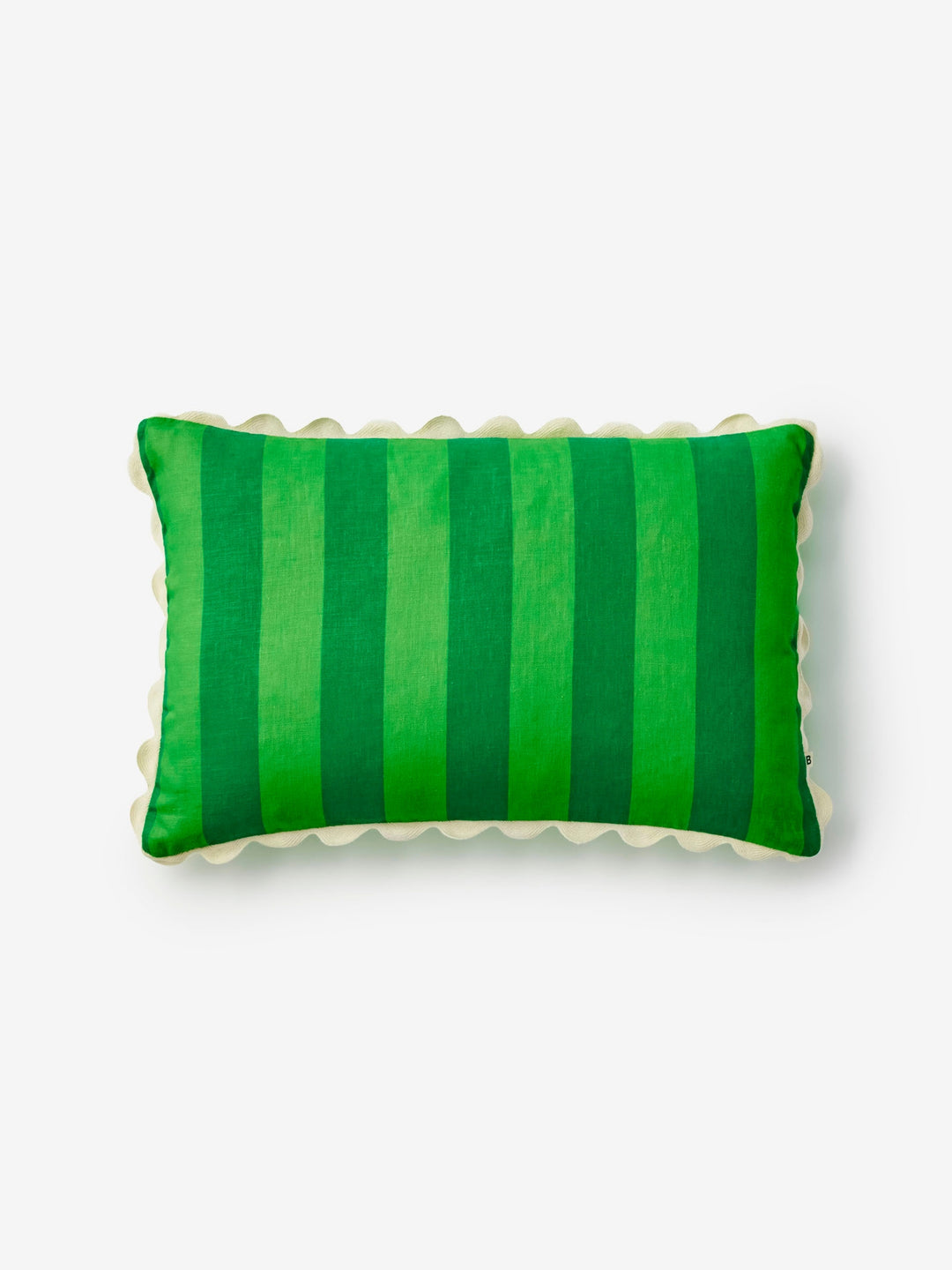Green striped pillow with cream scallop trim on a light gray background