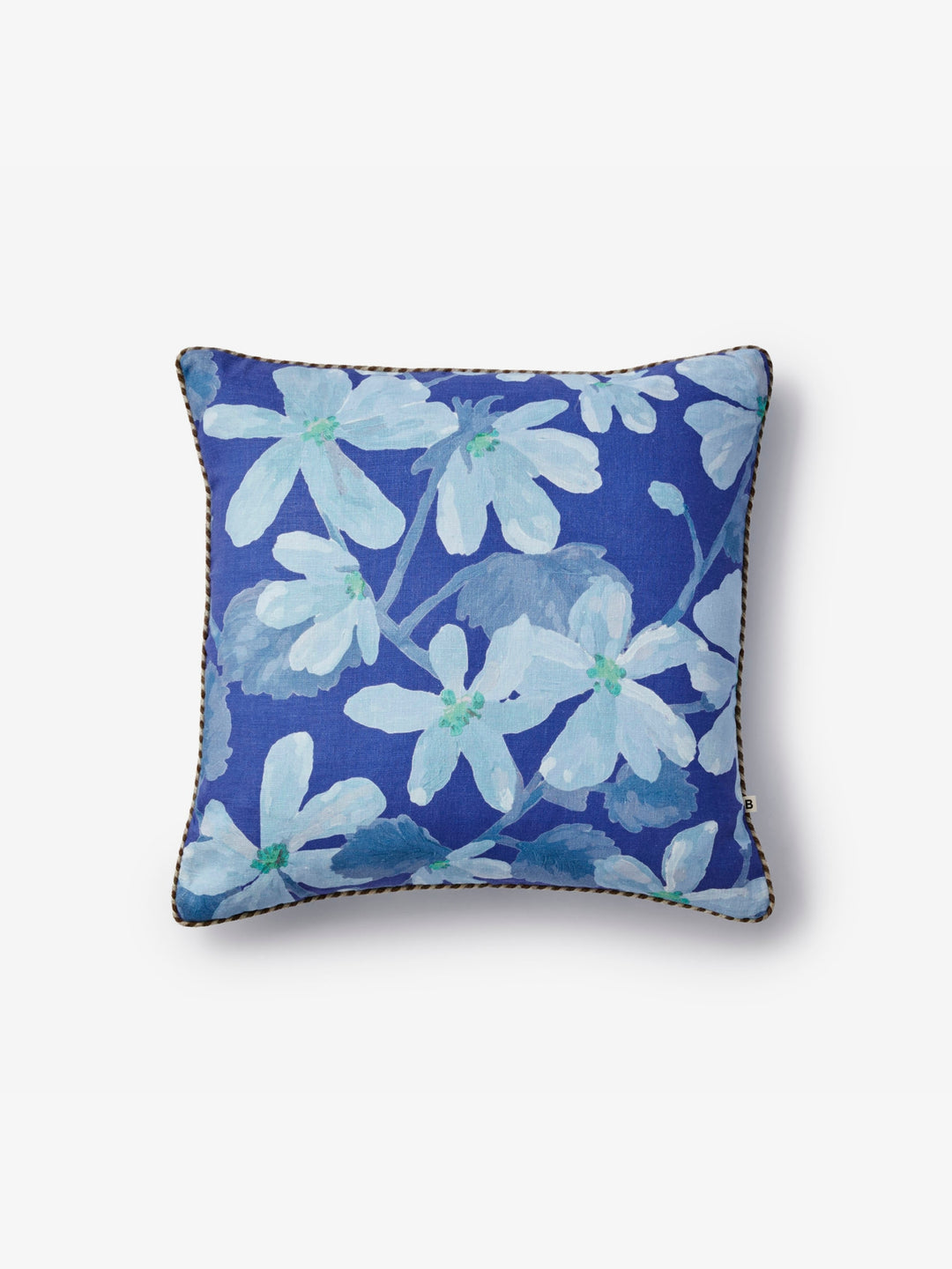 Blue floral pillow with braided raffia trim on a white background
