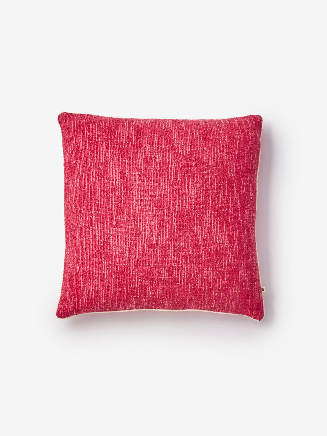 Pink textured pillow on a white background
