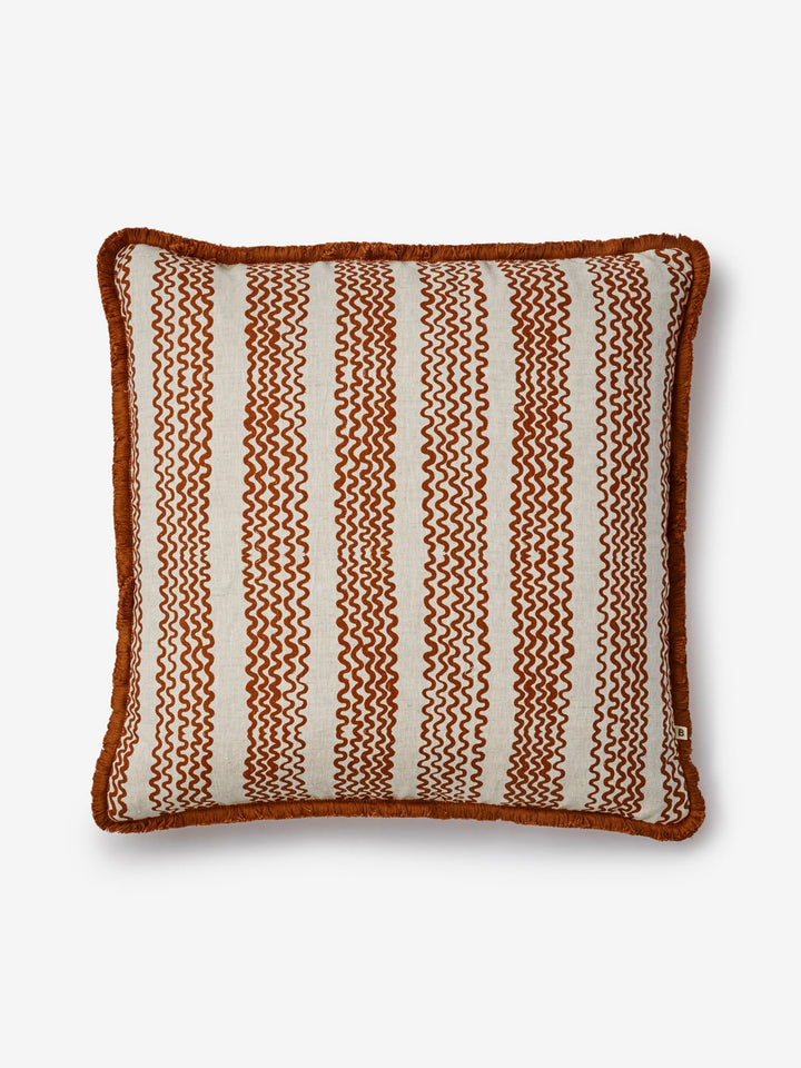 Decorative pillow with brown and white striped pattern on a light gray background