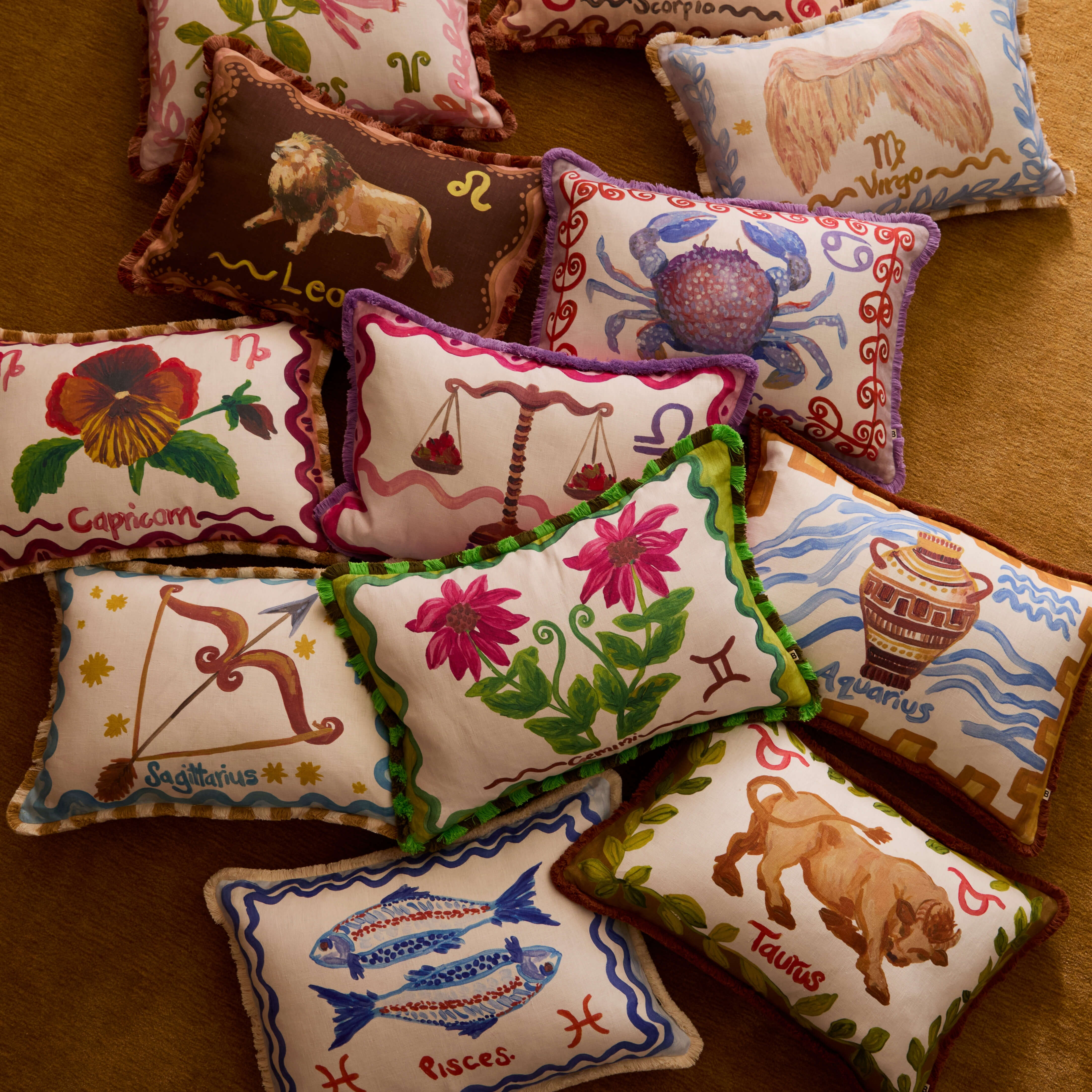 The  Zodiac collection cushions on the floor 