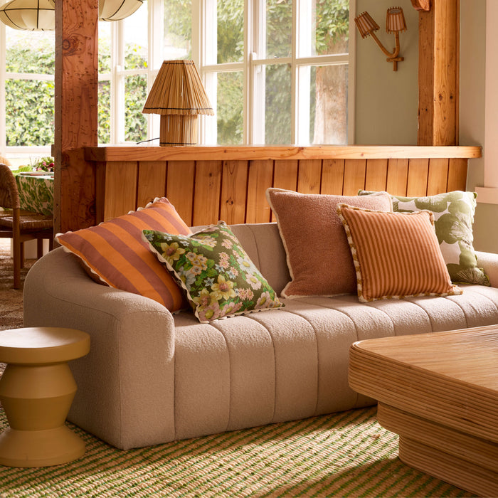 A lot of cushions on a  couch 