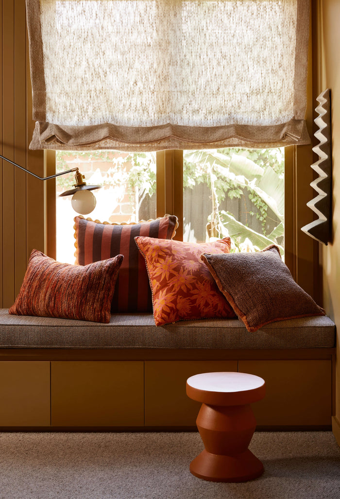 Cushions are placed on the bench seat by the window