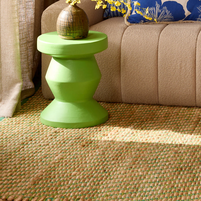 Cushions on a couch with a jute rug on the floor