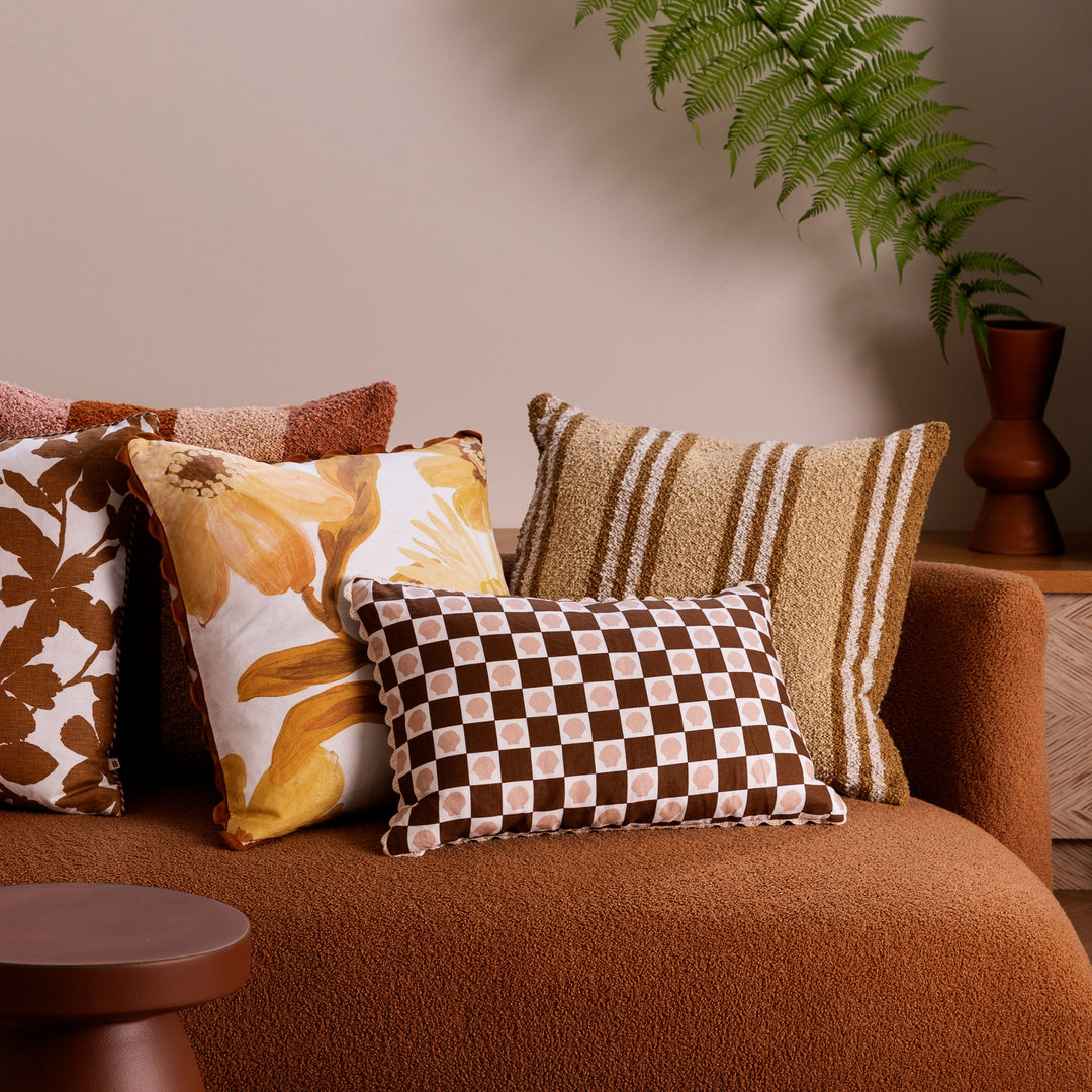 Shell Check Buff Rust 60x40cm Linen Cushion Styled On Brown Sofa With Complementary Cushions