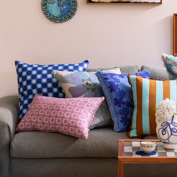 Tiny Aster Lilac 60x40cm Linen Cushion Styled On Blue Sofa With Complementary Cushions