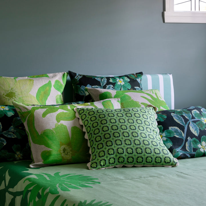 Tiny Aster Green 50cm Linen Cushion Styled On Bed With Complementary Cushions