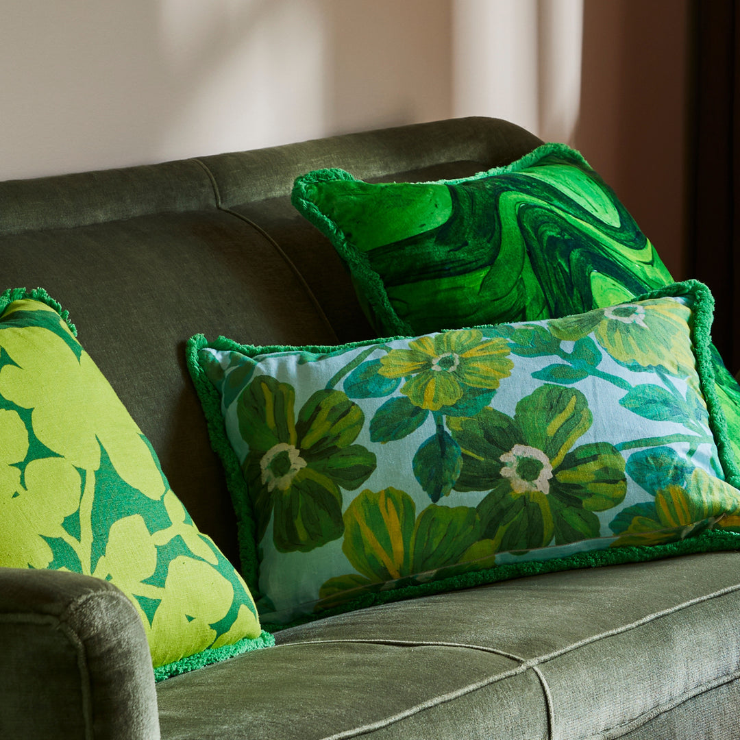 Carmine Lime 50cm Cushion Styled On Green Sofa With Rosetta Blue Cushion & Sway Green Cushion