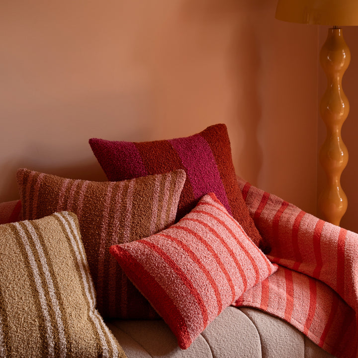 Wide Stripe Magenta 60cm Boucle Cushion Styled On Beige Sofa With Complementary Cushions