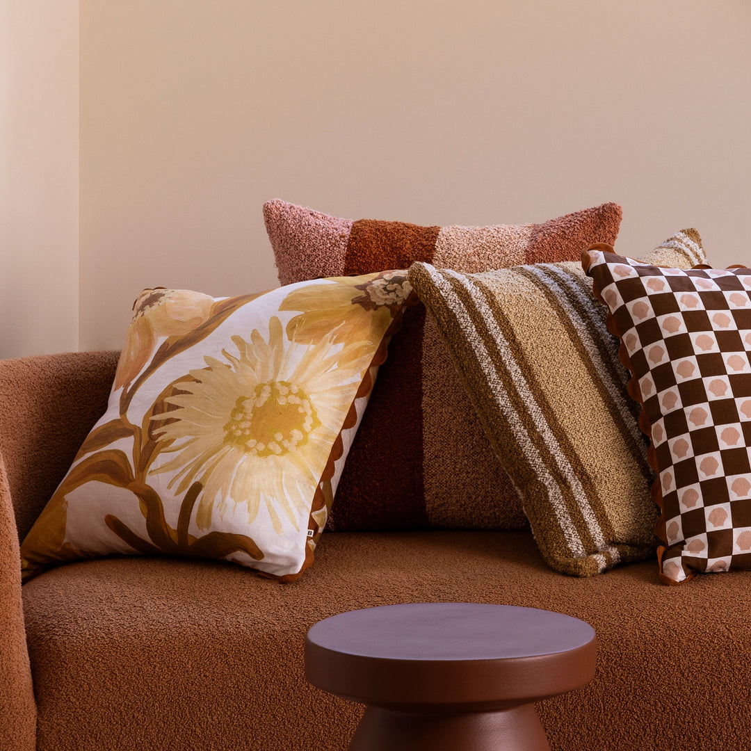 Cornflower Mustard 60cm Linen Cushion Styled On Brown Sofa With Complementary Cushions