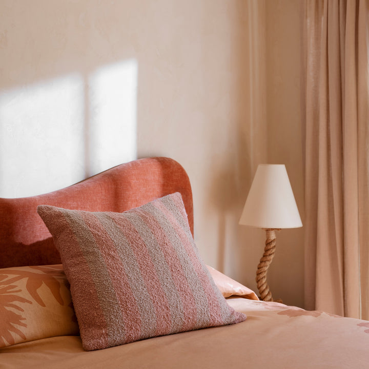 Boucle Stripe Soft Pink 60cm Cushion Styled On Bed With Flora Bed Cover