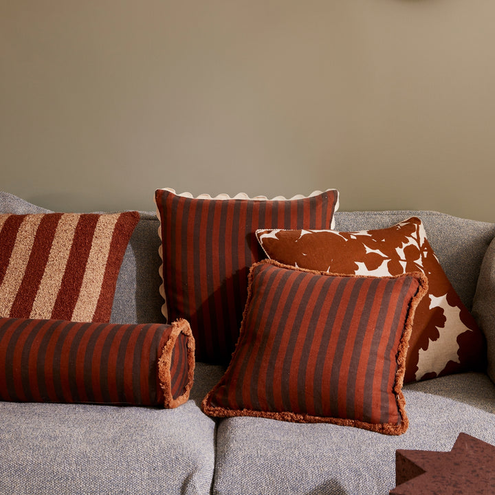 Thin Stripe Chocolate 60cm Cushion Styled On Grey Sofa With Brown Striped & Brown Floral Cushions