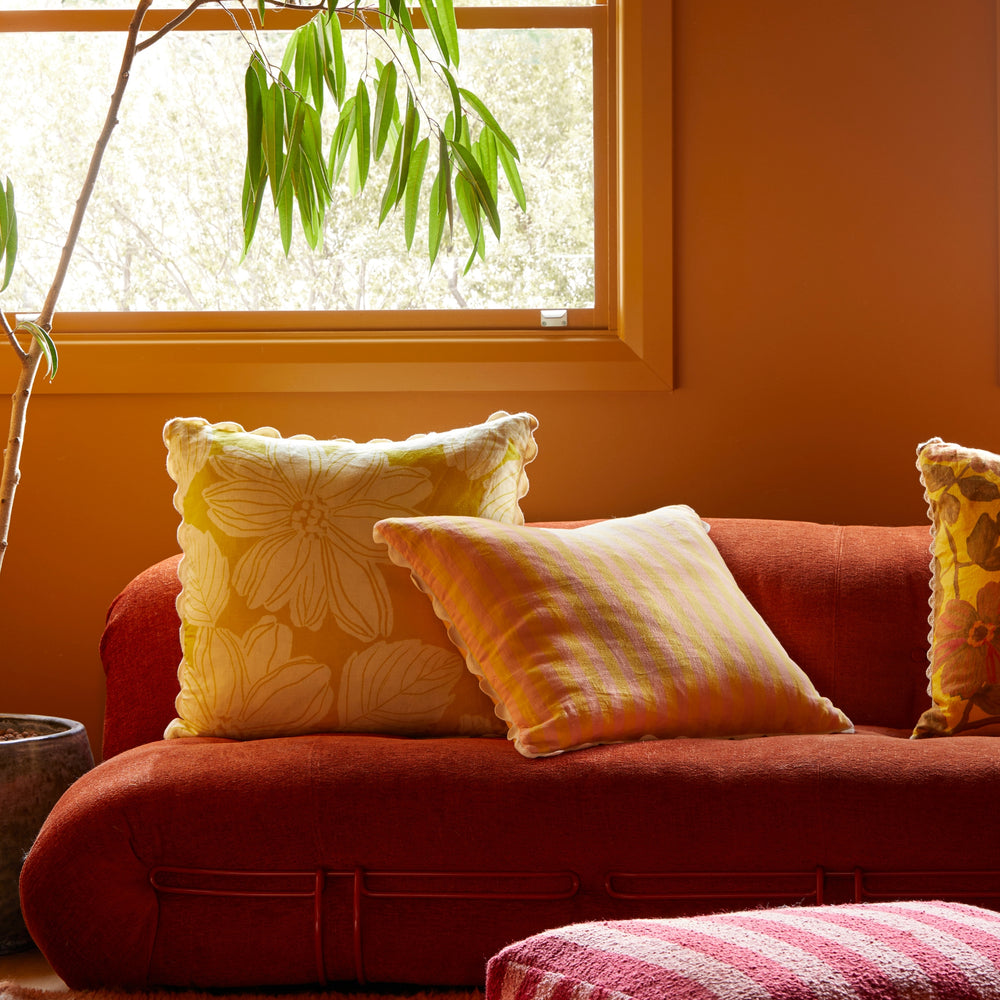 Margot Lemon 60cm Cushion Styled On Red Sofa With Thin Stripe Yellow Cushion 