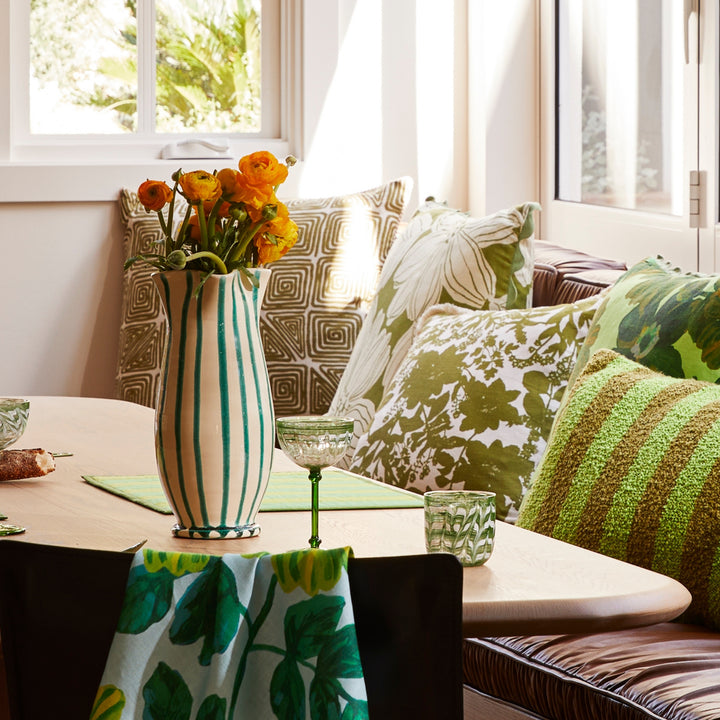 Maze Khaki 60cm Cushion Styled On Banquette Seating With Green Floral & Green Striped Cushions