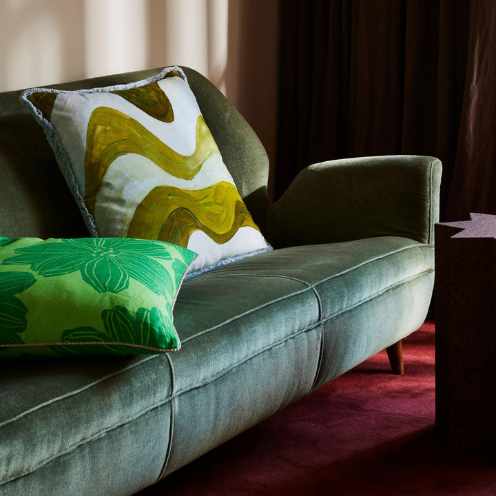 Sway Blue 60cm Velvet Cushion Styled On Green Sofa With Margot Bright Green Cushion