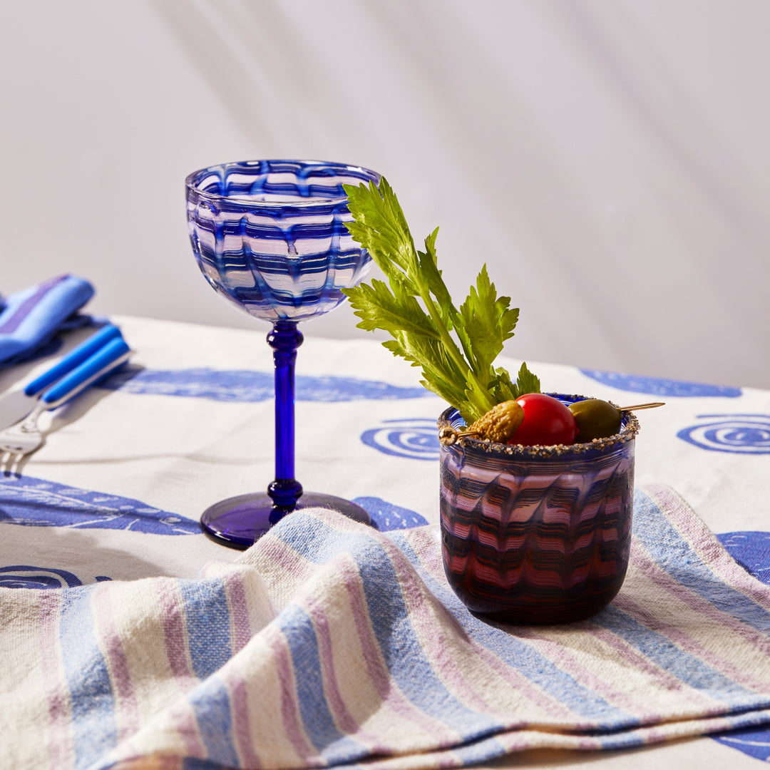 Watercolour Blue Coupe Glass Styled With Sardines Blue Tablecloth & Linear Blue Napkins