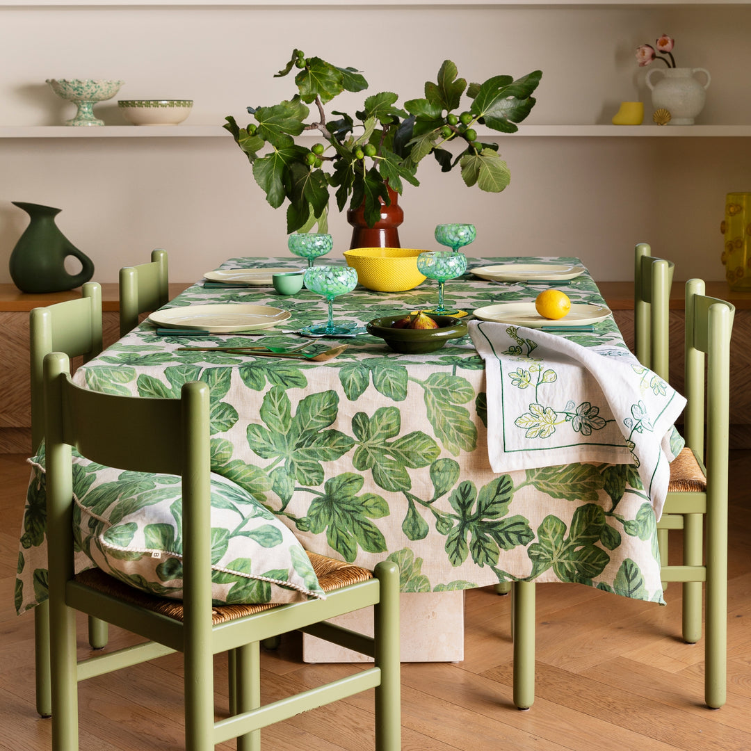 Fig Green Tablecloth Styled With Complementary Tabletop Accessories In Dining Room Setting